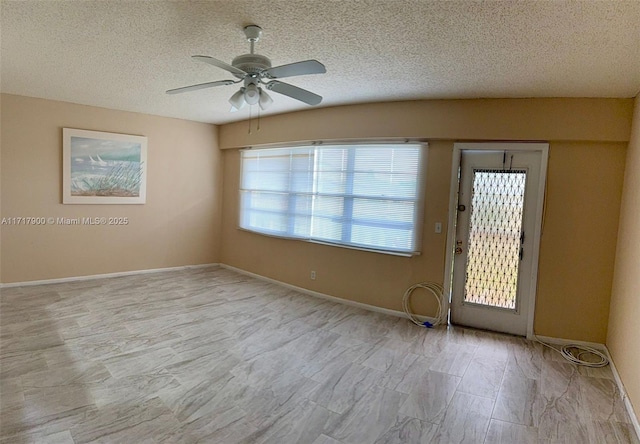 spare room featuring ceiling fan and a textured ceiling