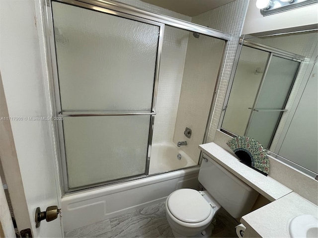 full bathroom featuring vanity, bath / shower combo with glass door, and toilet