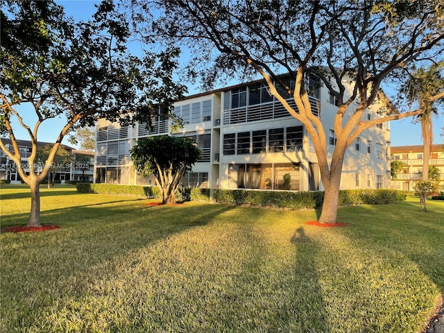 rear view of house featuring a lawn