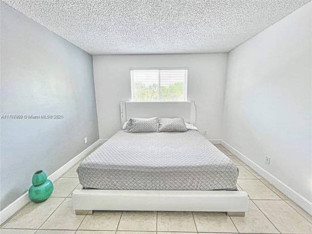 tiled bedroom with a textured ceiling