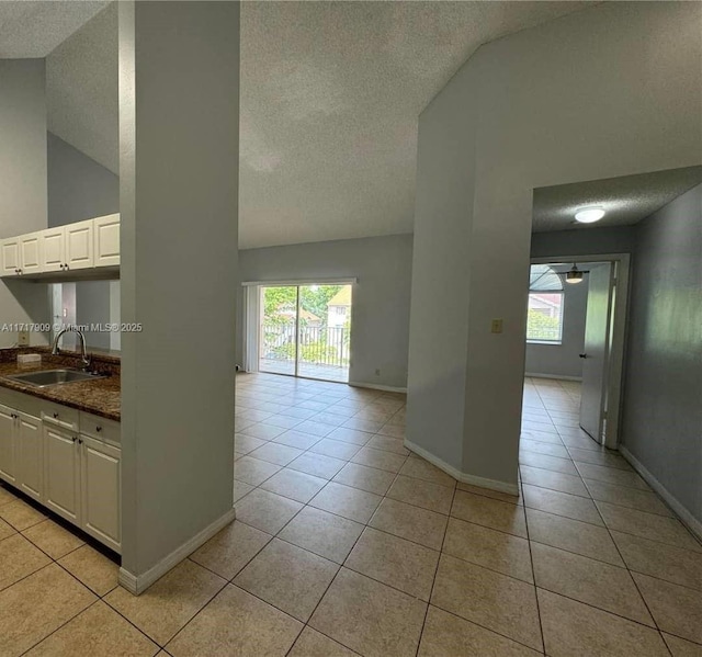 interior space featuring white cabinetry, sink, and light tile patterned flooring