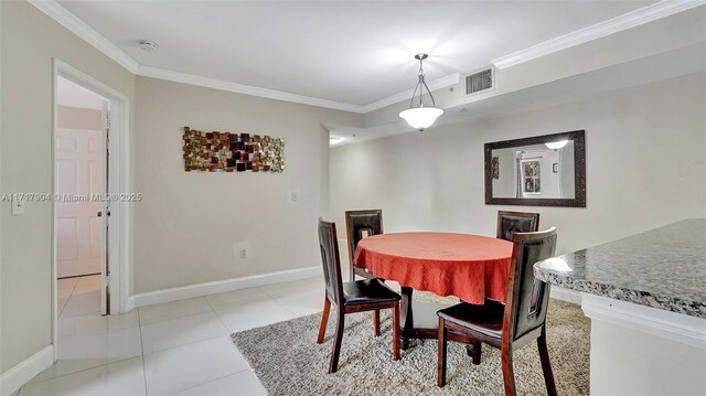 tiled dining room with ornamental molding