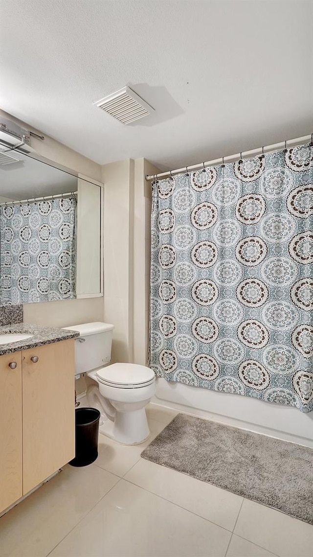 full bathroom featuring shower / bathtub combination with curtain, tile patterned flooring, vanity, and toilet