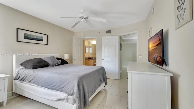 tiled bedroom featuring ceiling fan and ensuite bathroom