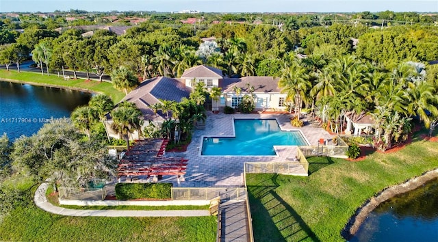 view of swimming pool with a water view and a yard