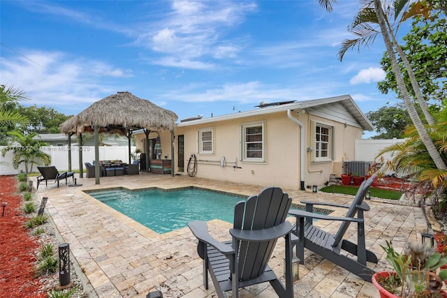 view of swimming pool with cooling unit, a patio, and an outdoor hangout area