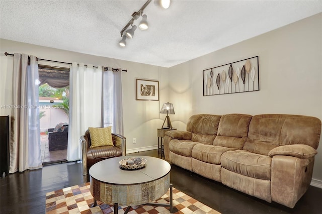 living room featuring a textured ceiling and dark hardwood / wood-style floors