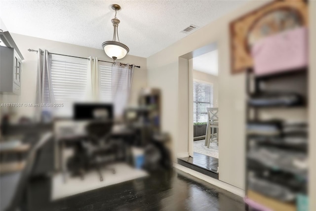 interior space featuring wood-type flooring and a textured ceiling