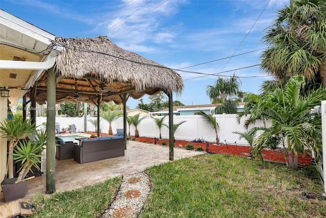 view of yard with a gazebo, ceiling fan, a pool, and a patio