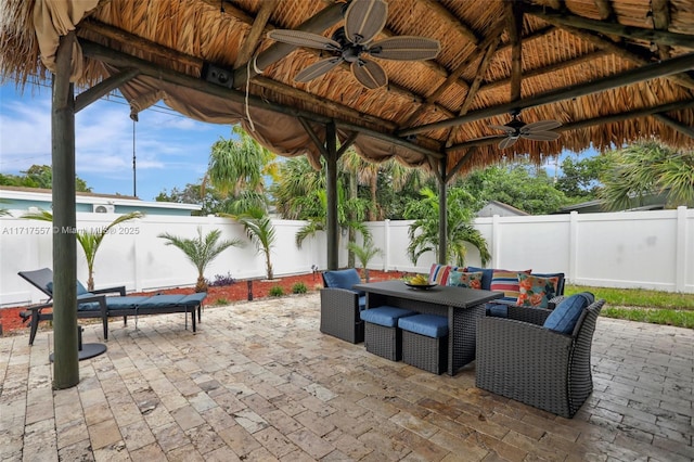 view of patio with a gazebo, ceiling fan, and an outdoor living space