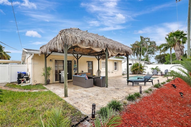 rear view of house featuring outdoor lounge area and a patio area