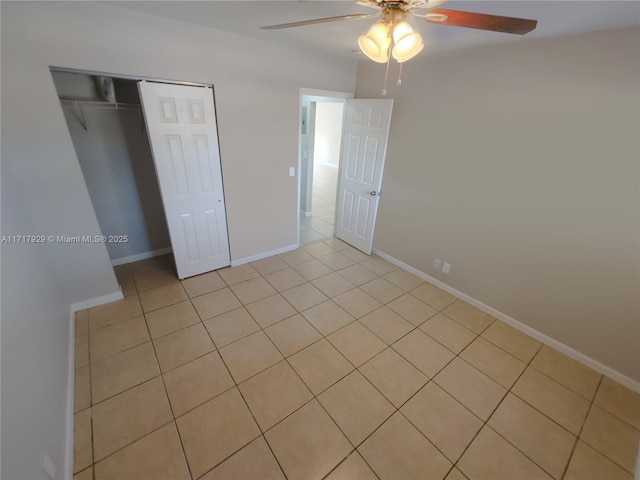 unfurnished bedroom with ceiling fan, a closet, and light tile patterned floors