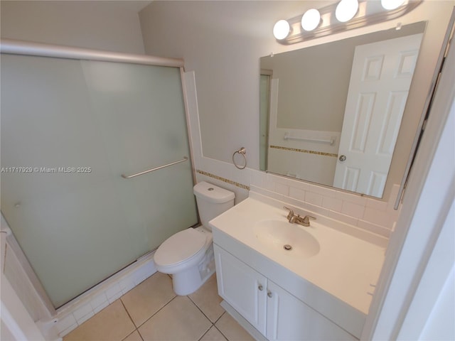 bathroom featuring vanity, tile patterned flooring, toilet, tasteful backsplash, and an enclosed shower