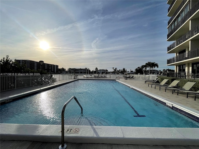 pool at dusk with a patio