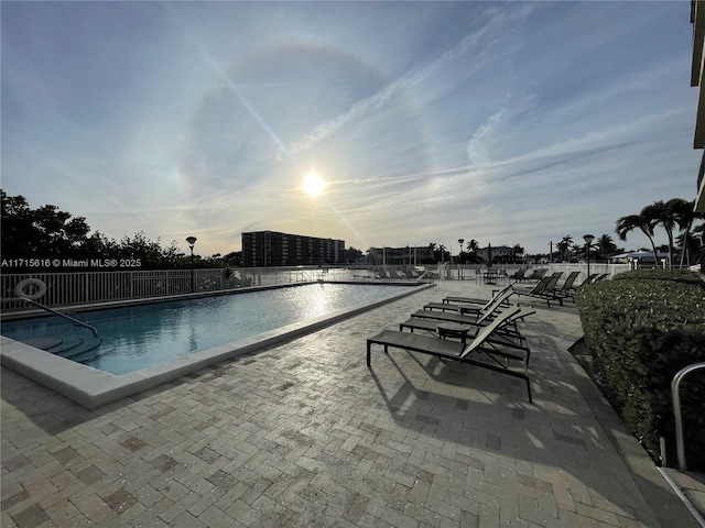 pool at dusk with a patio