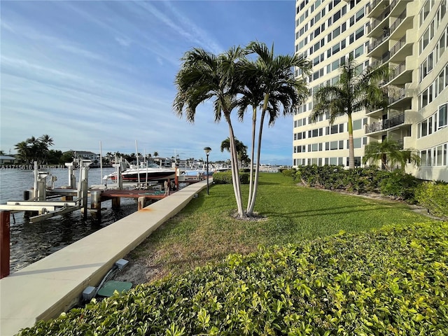 dock area with a yard and a water view