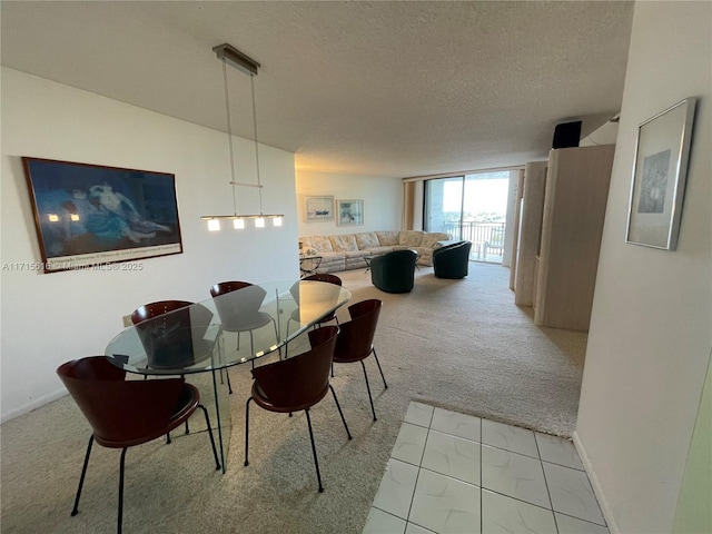 dining room featuring expansive windows, light colored carpet, and a textured ceiling