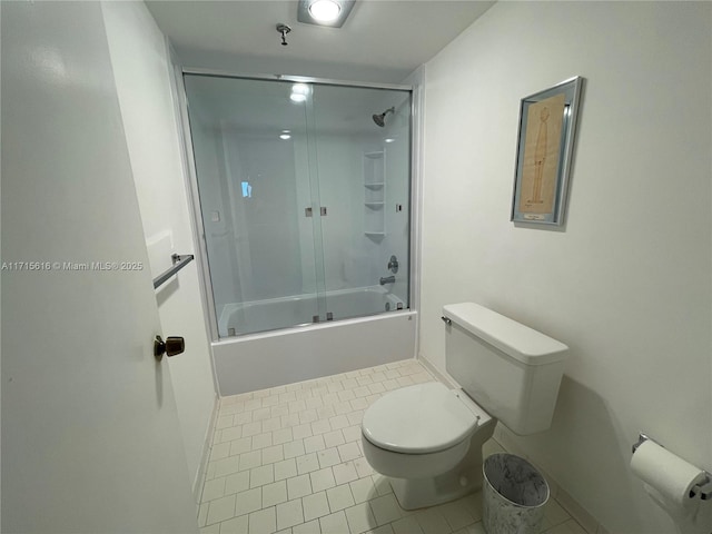 bathroom featuring shower / bath combination with glass door, tile patterned floors, and toilet