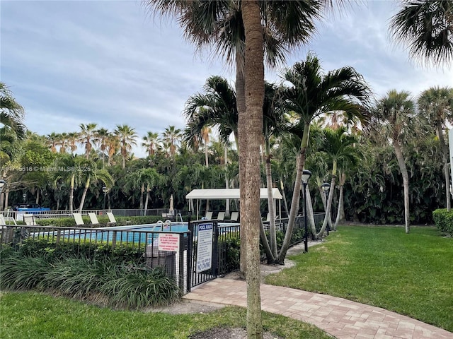 view of swimming pool with a lawn