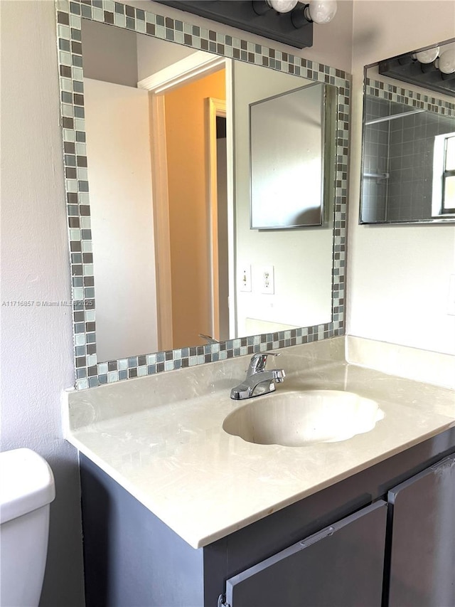 bathroom with vanity and toilet