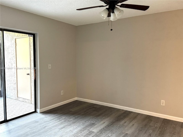 unfurnished room with a textured ceiling, dark hardwood / wood-style floors, and ceiling fan