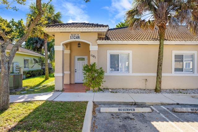 mediterranean / spanish home with a front lawn