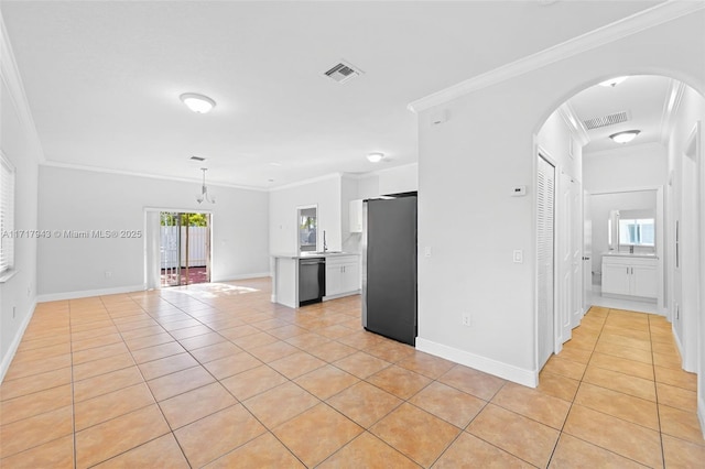 interior space featuring appliances with stainless steel finishes, a healthy amount of sunlight, crown molding, white cabinetry, and light tile patterned flooring