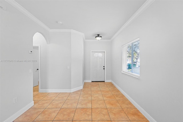 foyer entrance with light tile patterned floors and ornamental molding