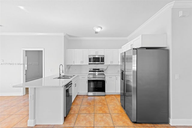 kitchen with sink, light tile patterned floors, appliances with stainless steel finishes, white cabinets, and ornamental molding