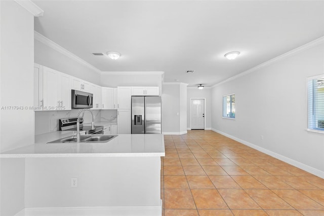 kitchen featuring white cabinetry, crown molding, light tile patterned floors, and appliances with stainless steel finishes