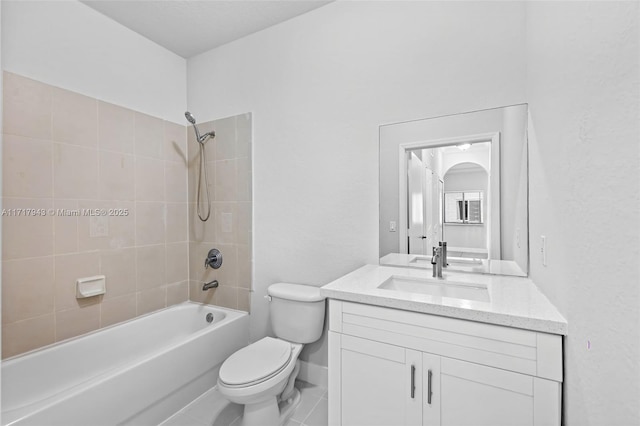 full bathroom featuring vanity, tiled shower / bath combo, toilet, and tile patterned flooring