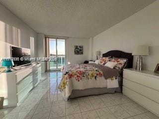 tiled bedroom featuring access to exterior and floor to ceiling windows