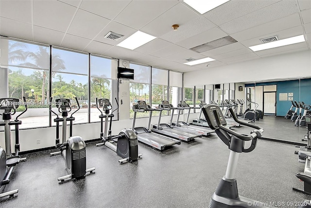 exercise room with a paneled ceiling