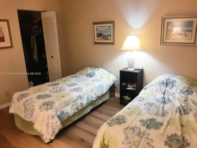 bedroom with hardwood / wood-style flooring and a closet