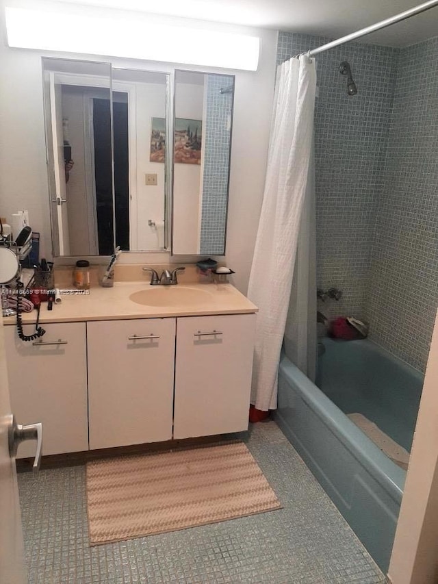 bathroom with vanity, tile patterned floors, and shower / bath combo with shower curtain