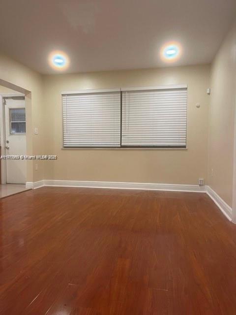 empty room featuring dark wood-type flooring