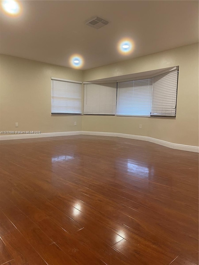 spare room with dark wood-type flooring