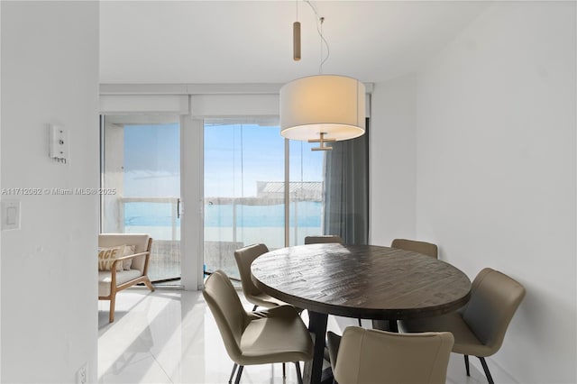 tiled dining area featuring a water view