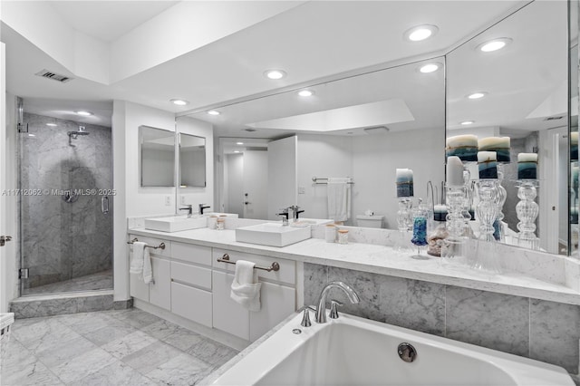 full bathroom featuring shower with separate bathtub, vanity, and toilet