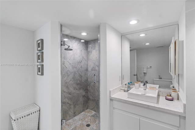 bathroom with vanity, toilet, and a shower with door