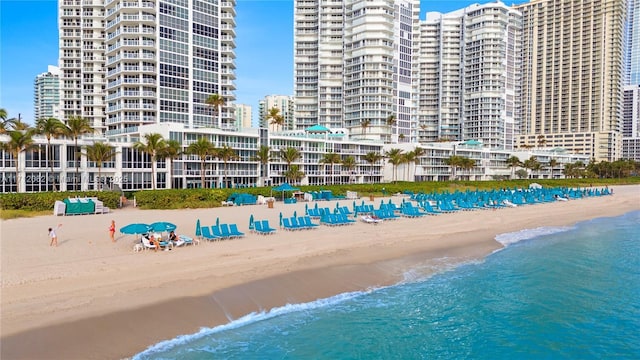 exterior space with a water view and a beach view