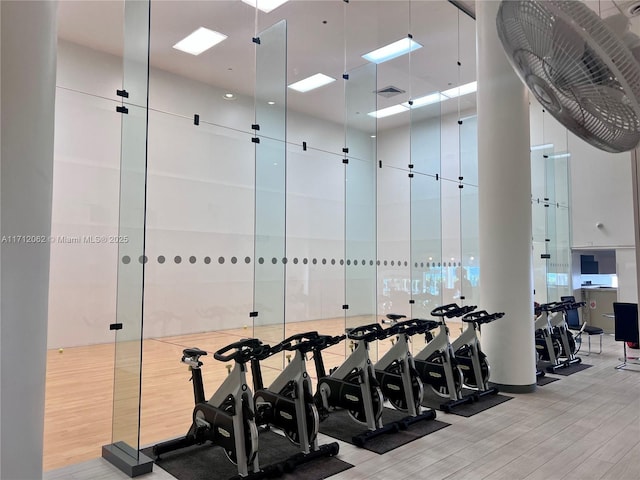 exercise room with light hardwood / wood-style flooring