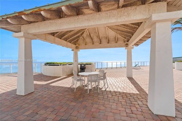 view of patio featuring a gazebo and a water view