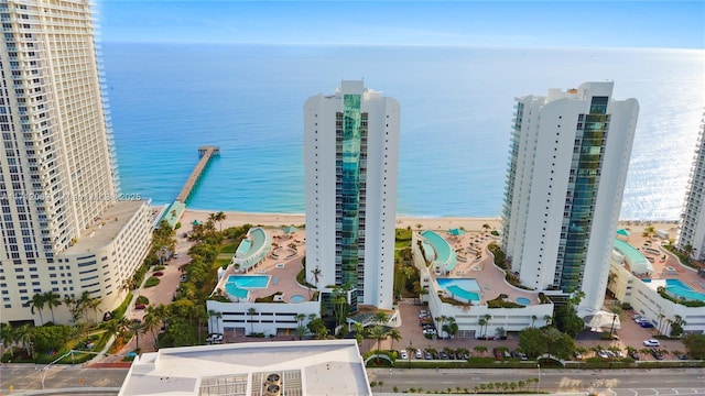 drone / aerial view featuring a beach view and a water view