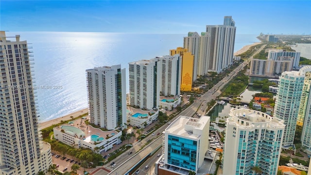 bird's eye view with a water view and a beach view