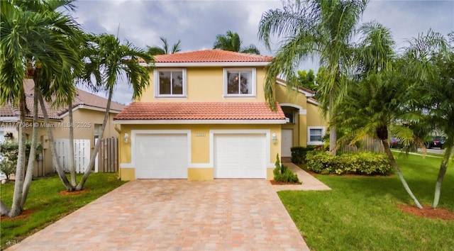 view of front of property with a front yard and a garage