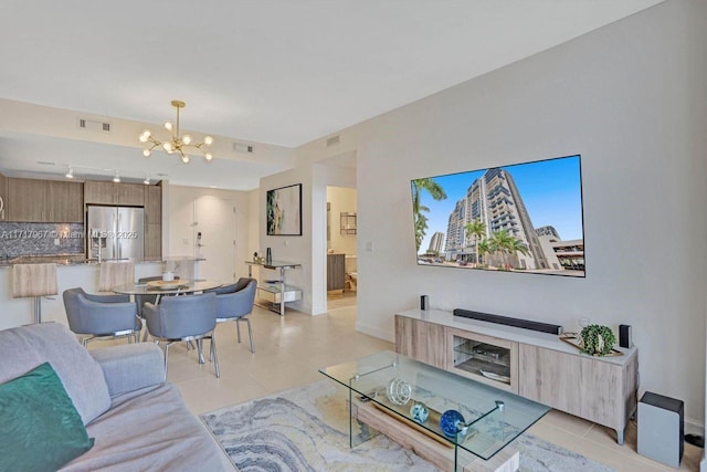 tiled living room featuring a notable chandelier