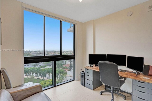 office area with floor to ceiling windows and light tile patterned flooring