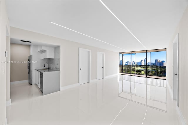 living room featuring sink and expansive windows