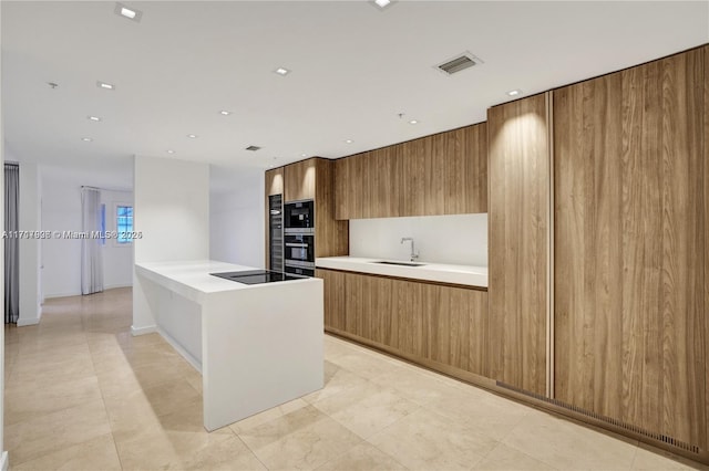 kitchen with oven, sink, black electric cooktop, built in microwave, and kitchen peninsula